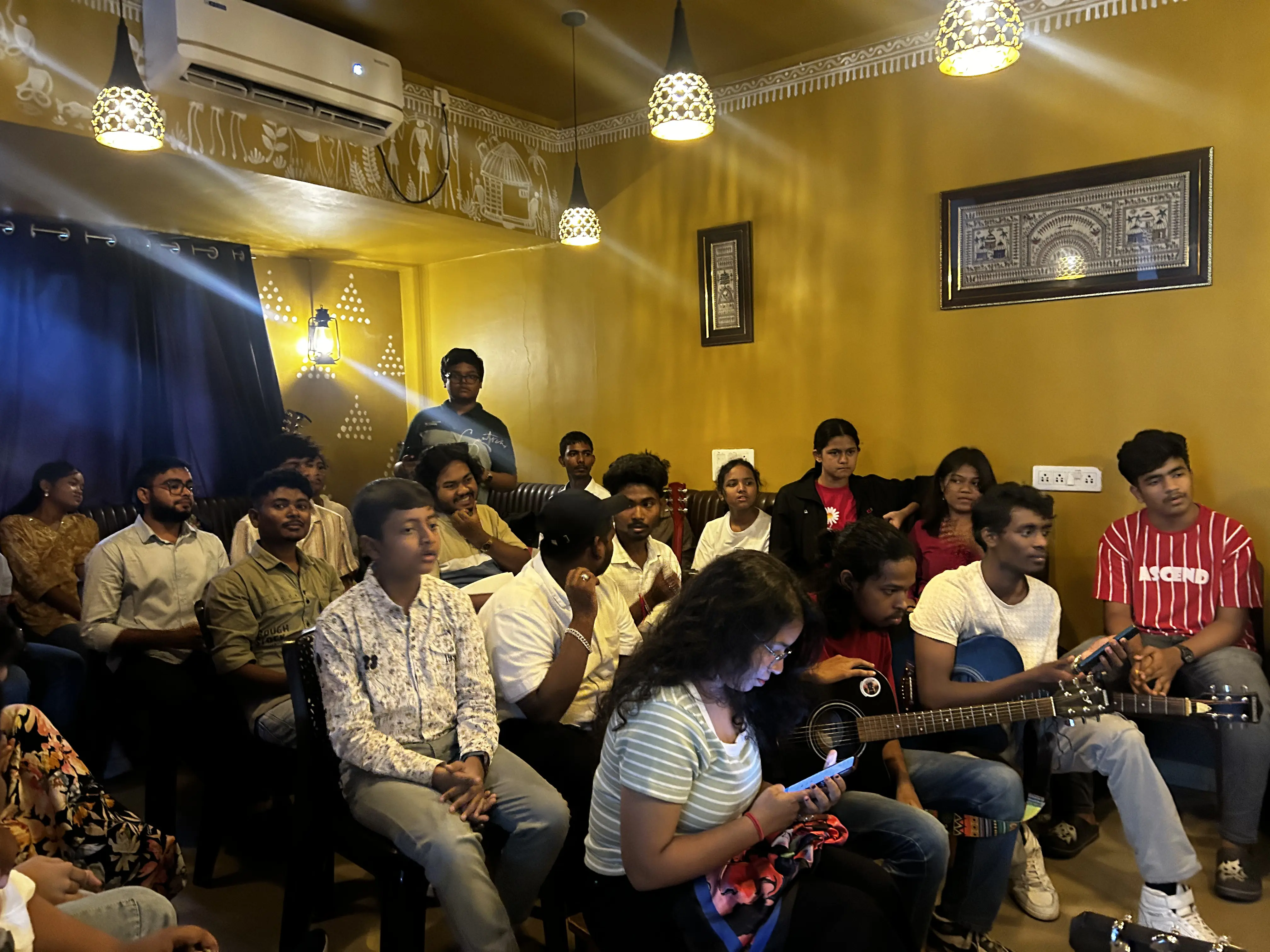Music and gathering event at JOMHA Restaurant with tribal Warli art decor