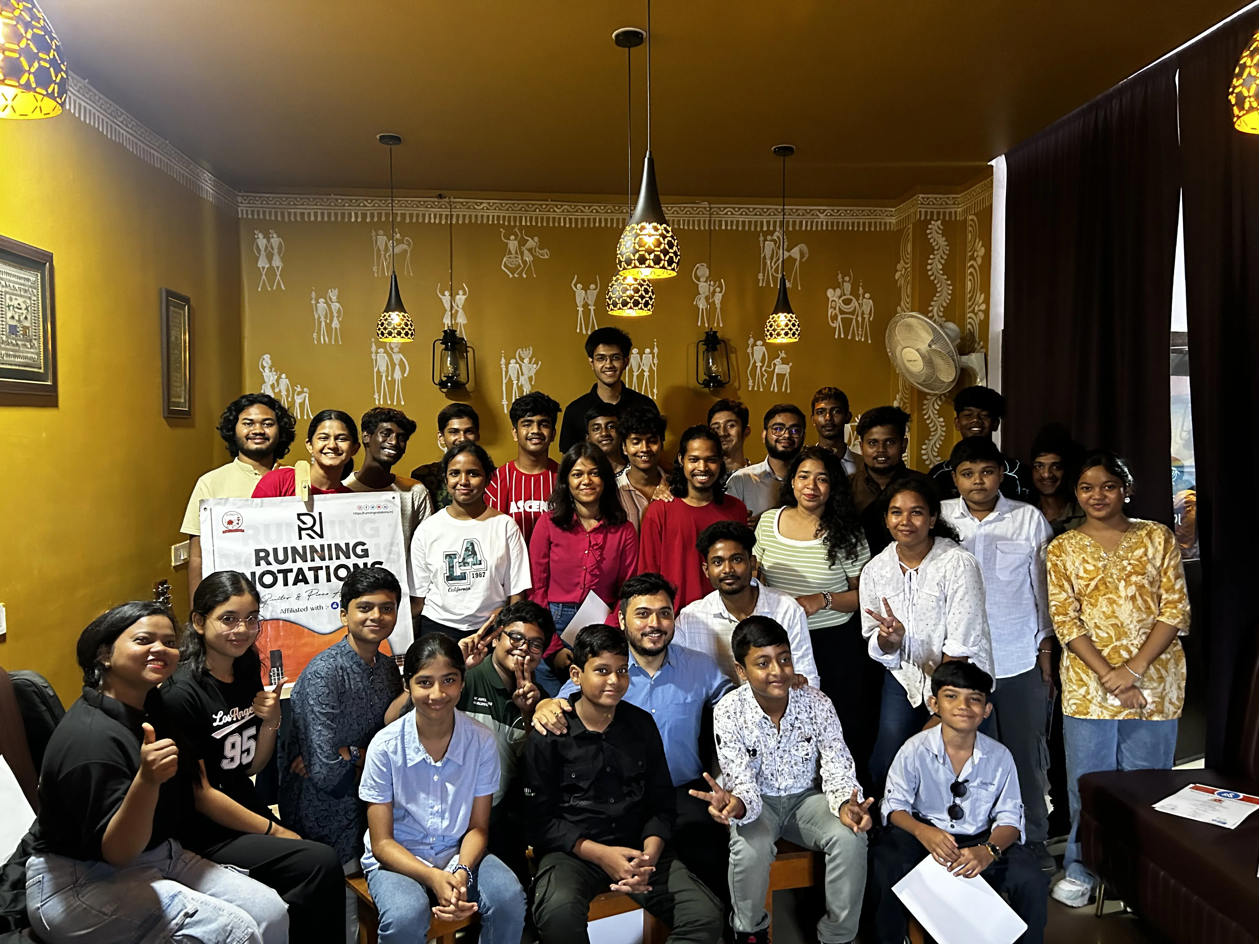 Running Notation event group photo at JOMHA Restaurant with tribal decor