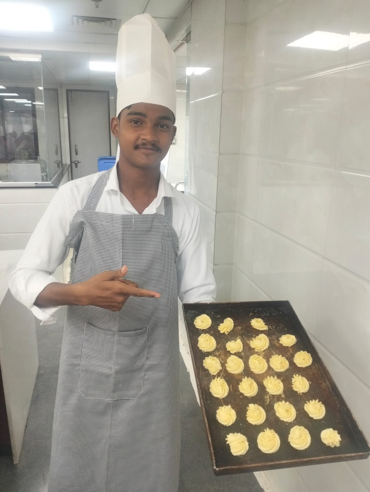 Chef showcasing pastry creations at JOMHA